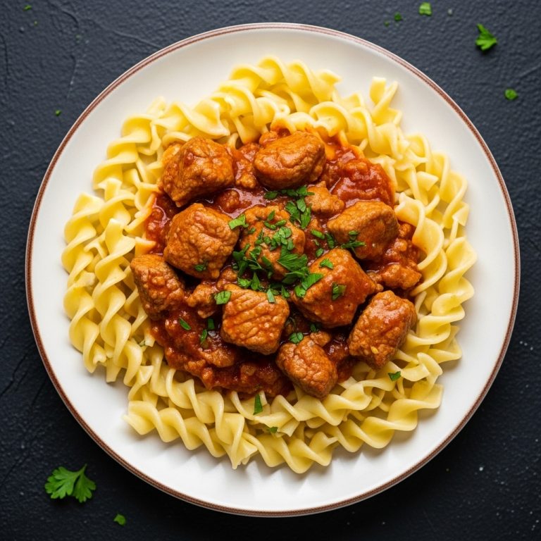 Succulent Hungarian Pork Goulash Bites on Buttered Egg Noodles